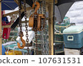 A seashore port town piled with fishery-related tools, chains, pulleys, and fishing nets 107631531