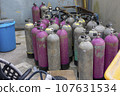 a warehouse with a stack of oxygen tanks 107631534