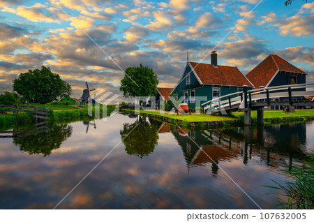 Sunset above historic farm houses in the holland village of Zaanse Schans Sunset above historic farm houses in the holland village of Zaanse Schans 107632005