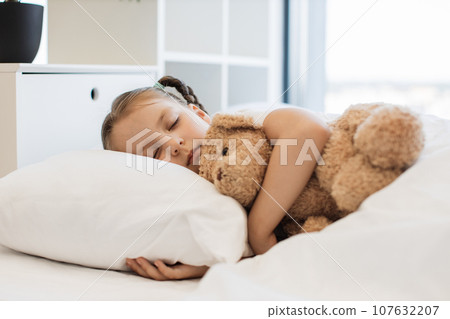 Cute ill girl sleeping sweet with teddy bear at home Cute ill girl sleeping sweet with teddy bear at home 107632207
