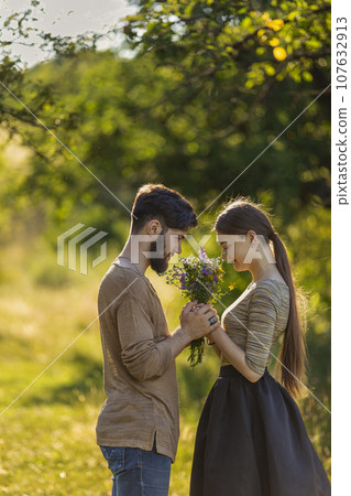 couple in nature with wildflowers couple in nature with wildflowers 107632913