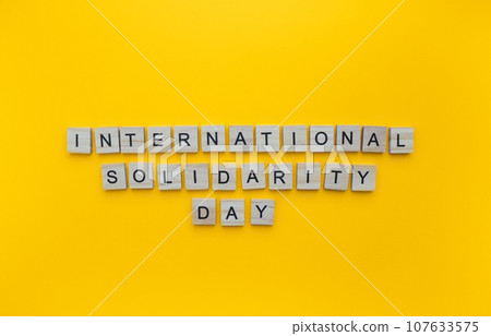 December 20, International Solidarity Day, minimalistic banner with the inscription in wooden letters 107633575