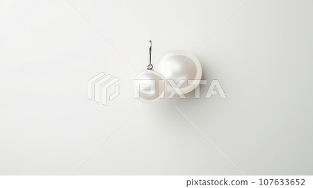 a pair of beautiful and classy pearl earrings made of two large white pearls attached to a thin silver wire. The pearls have a smooth and shiny surface that reflects light. The image has a high a pair of beautiful and classy pearl earrings made of two large white pearls attached to a thin silver wire. The pearls have a smooth and shiny surface that reflects light. The image has a high 107633652
