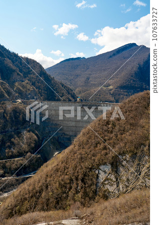 The dam of the Inguri hydroelectric power plant in the Sakartvelo mountains. A natural mountain landscape with energetic infrastructure The dam of the Inguri hydroelectric power plant in the Sakartvelo mountains. A natural mountain landscape with energetic infrastructure 107633727
