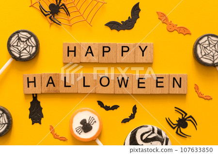 Halloween concept - creative backgrtound with festive sweets, spiders, bats 107633850