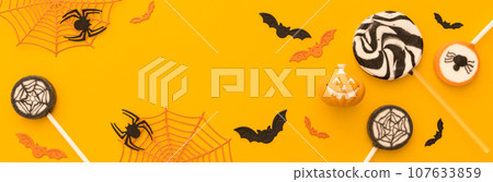 Halloween concept - creative backgrtound with festive sweets, spiders, bats 107633859
