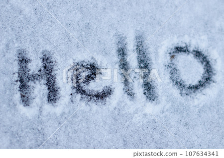 Inscription on the snow the word Hello 107634341