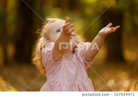 Autumn. Baby girl spinning and laughing in autumn 107634471