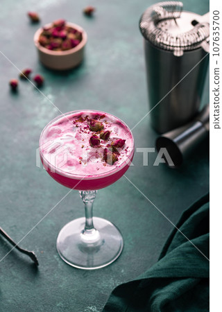 Summer pink cocktail with rose flowers Summer pink cocktail with rose flowers 107635700