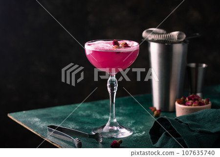 Summer pink cocktail with rose flowers Summer pink cocktail with rose flowers 107635740