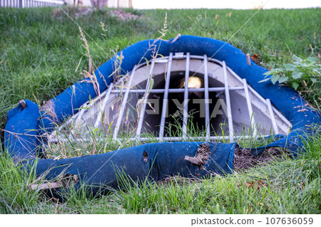 Filter sock staked around a storm intake grating 107636059