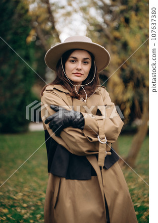 A young woman in a brown dress and hat. A young woman in a brown dress and hat. 107637380