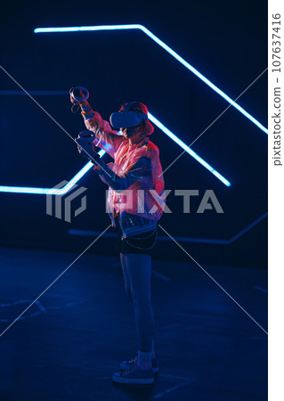 Young female gamer connect to virtual reality. Young female gamer connect to virtual reality. 107637416