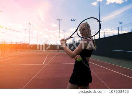 Sensual woman with tennis racket at net on lawn. Activity, energy, power. Sport, training, workout. Sensual woman with tennis racket at net on lawn. Activity, energy, power. Sport, training, workout. 107638433