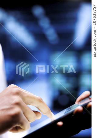 Adept engineer writing data center disaster contingency plan on tablet to provide rapid restoration of service, limit disruption and minimize interruptions to normal operations 107638757