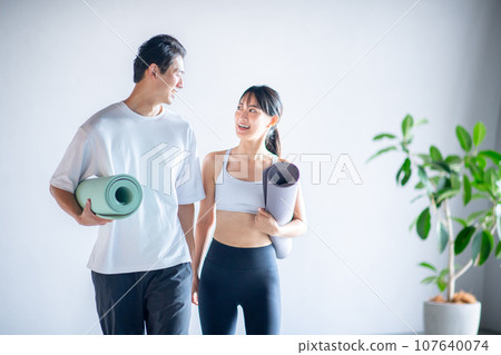 Men and women attending a fitness club Men and women attending a fitness club 107640074
