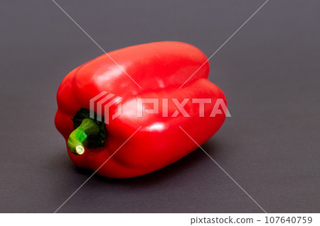 Red Bell Pepper on Black Background 107640759