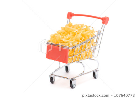 Uncooked Fusilli Pasta in Small Shopping Cart Isolated on White Uncooked Fusilli Pasta in Small Shopping Cart Isolated on White 107640778