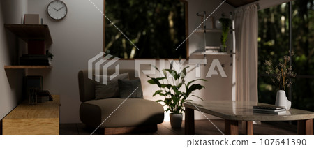 Interior design of a modern cosy living room at night with a comfy chair, a coffee table and decor. Interior design of a modern cosy living room at night with a comfy chair, a coffee table and decor. 107641390