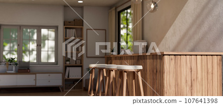 A modern Scandinavian home kitchen with a wooden kitchen island or counter, stools, and accessories. 107641398