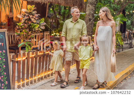 A joyful family, two girls, dad, and a pregnant mom, bask in tropical resort, celebrating a radiant pregnancy amidst paradise A joyful family, two girls, dad, and a pregnant mom, bask in tropical resort, celebrating a radiant pregnancy amidst paradise 107642232