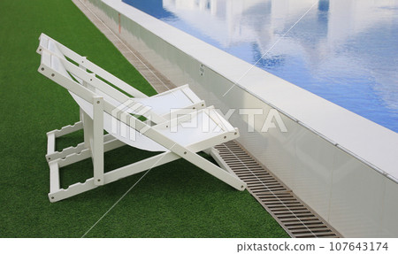white beach deck canvas chair bed longue on the green grass 107643174