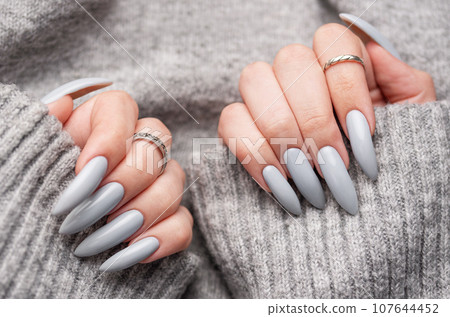 Woman's hand with grey nail polish 107644452