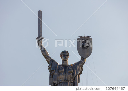 Kyiv, Ukraine - August 1, 2023: A view of Motherland monument after removed of Soviet coat of arms and preparing for installation of the coat of arms of Ukraine Kyiv, Ukraine - August 1, 2023: A view of Motherland monument after removed of Soviet coat of arms and preparing for installation of the coat of arms of Ukraine 107644467