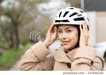 young woman wearing a cycling helmet young woman wearing a cycling helmet 107646193