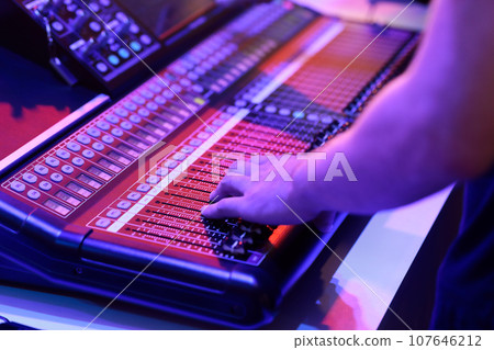 audio engineer working with sound mixing console audio engineer working with sound mixing console 107646212