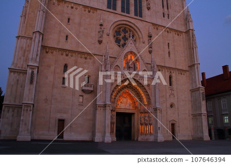 Evening view of the Cathedral of the Assumption of the Virgin Mary with its two high spires in the Kaptol district of Zagreb, the capital of Croatia in southern Europe Evening view of the Cathedral of the Assumption of the Virgin Mary with its two high spires in the Kaptol district of Zagreb, the capital of Croatia in southern Europe 107646394