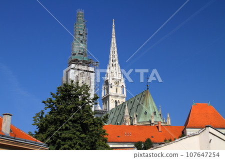 The two spiers of the Cathedral of the Assumption of the Virgin Mary, a symbol of the Kaptol district of Zagreb, the capital of Croatia in southern Europe 107647254