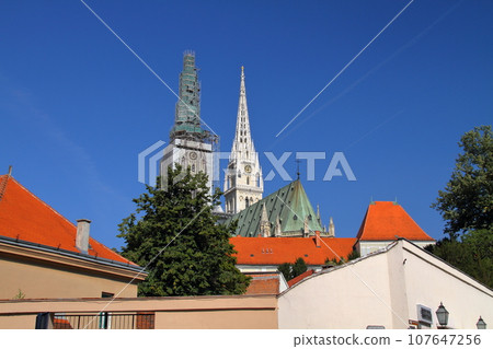 The two spiers of the Cathedral of the Assumption of the Virgin Mary, a symbol of the Kaptol district of Zagreb, the capital of Croatia in southern Europe 107647256