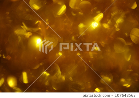 Shiny golden lights out of focus, sparkling festive background with bokeh. Holiday shiny gold backdrop Shiny golden lights out of focus, sparkling festive background with bokeh. Holiday shiny gold backdrop 107648562