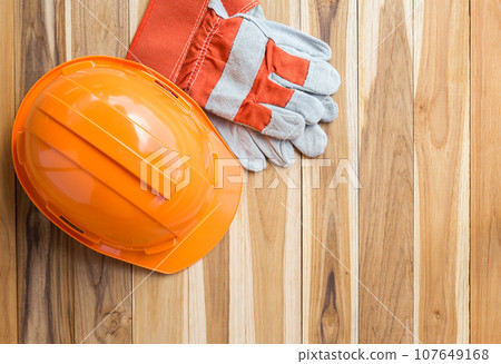 Orange safety engineer helmet gear and gloves Orange safety engineer helmet gear and gloves 107649168
