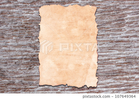 Old paper on brown aged wood 107649364