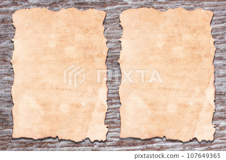 Old paper on brown aged wood Old paper on brown aged wood 107649365