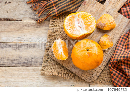 Tangerines on a wooden table background 107649783