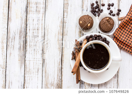Coffee cup and cookie on white wooden table Coffee cup and cookie on white wooden table 107649826