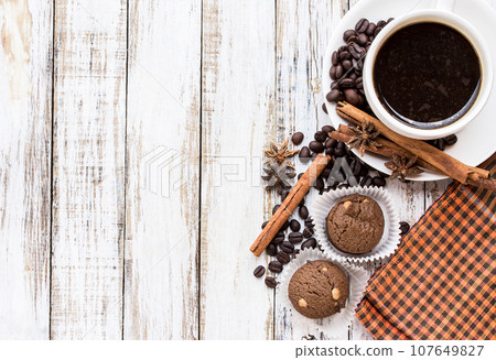 Coffee cup and cookie on white wooden table Coffee cup and cookie on white wooden table 107649827