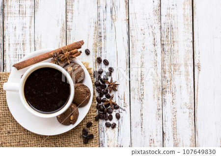 Coffee cup and cookie on white wooden table Coffee cup and cookie on white wooden table 107649830