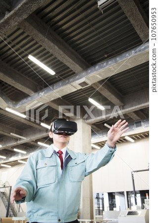 Young worker using VR in a warehouse Young worker using VR in a warehouse 107650953