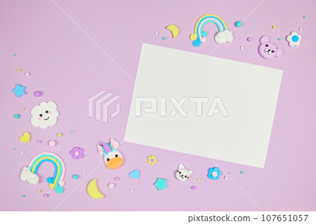Blank white card on pastel purple background with kawaii cartoon animals 107651057