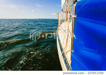 Yachting on sail boat during sunny weather 107651599