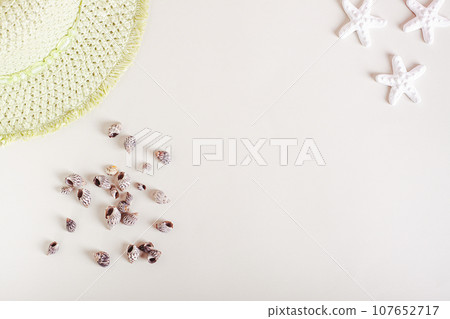 Summer light background for vacation with seashells, starfish and hat top view Summer light background for vacation with seashells, starfish and hat top view 107652717