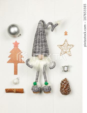 Layout of New Year's toys, accessories, gifts on a light wooden background. New Year background. Layout of New Year's toys, accessories, gifts on a light wooden background. New Year background. 107653385