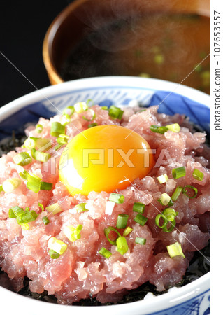 Seared tuna bowl topped with green onion and egg yolk and piping hot miso soup Seared tuna bowl topped with green onion and egg yolk and piping hot miso soup 107653557