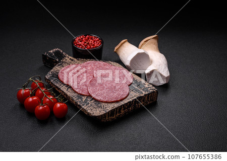 Delicious fresh smoked sausage with salt and spices cut into slices 107655386