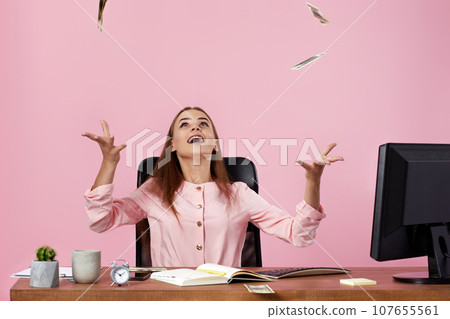pretty businesswoman throwing money on pink background. pretty businesswoman throwing money on pink background. 107655561