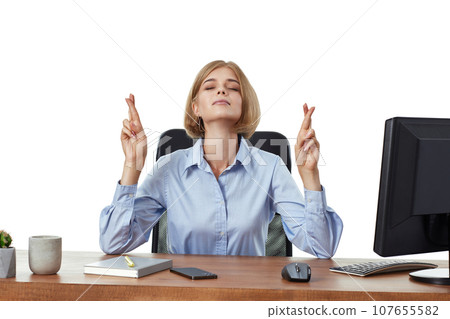 businesswoman showing fingers crossed for good luck in office businesswoman showing fingers crossed for good luck in office 107655582